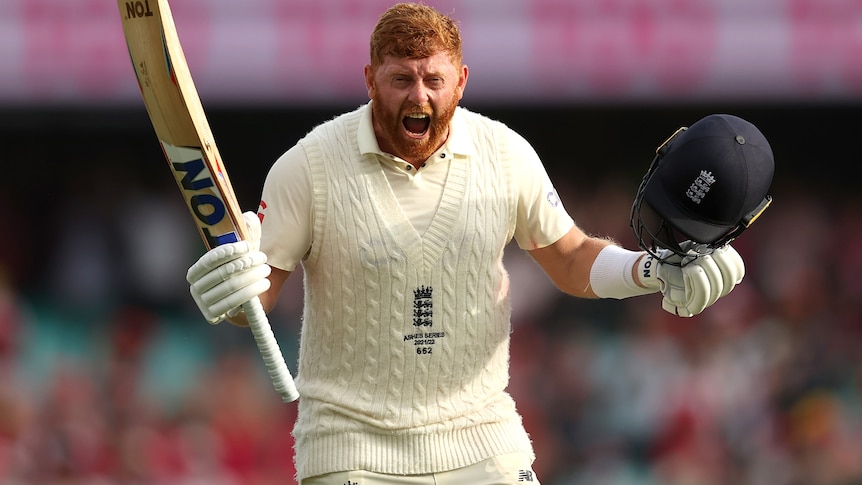 Jonny Bairstow holds his bat and his helmet and screams in delight