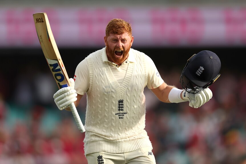 Jonny Bairstow holds his bat and his helmet and screams in delight