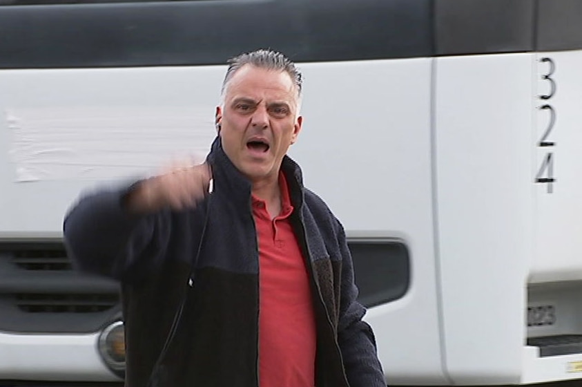 Angry Tyremil owner Tony Di Carlo waves finger at ABC cameraman at the site of the Rocklea fire on June 27, 2017