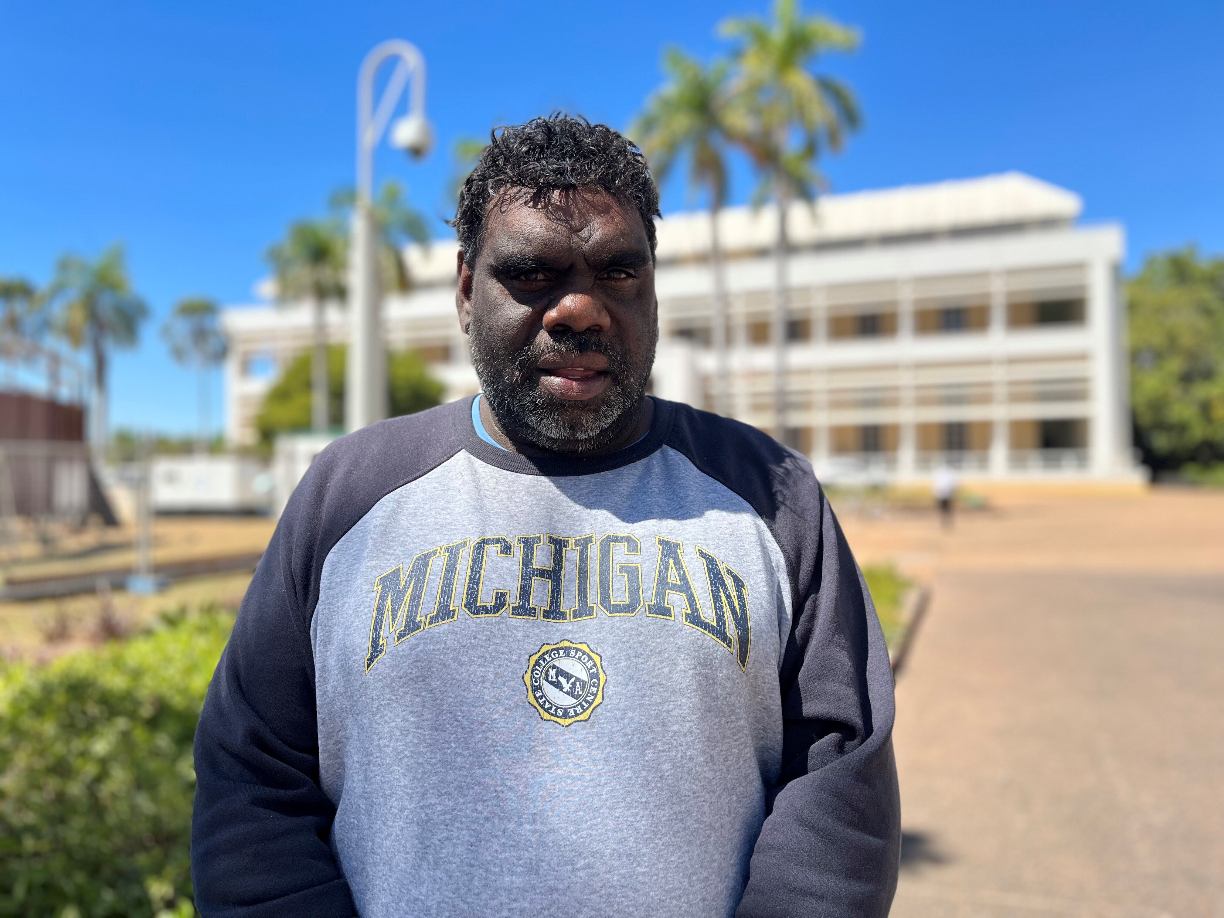 Nathaniel Morton stands outside NT parliament in Darwin.
