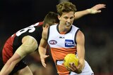 Lachie Whitfield of the Giants runs with the ball