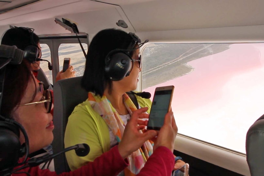 Chinese tourists on a flight over the pink lakes at Hutt Lagoon.