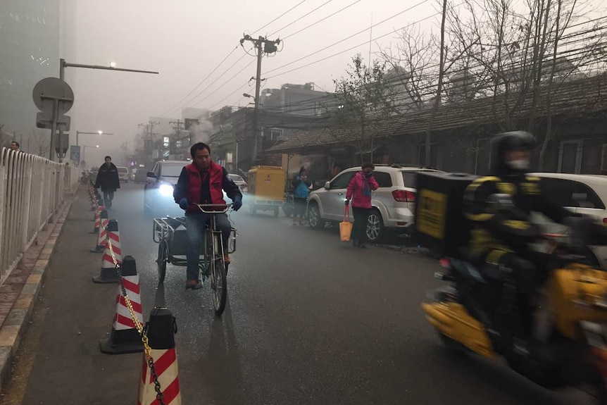 People travel on roads in Beijing, China amid smog and air pollution December 19, 2015