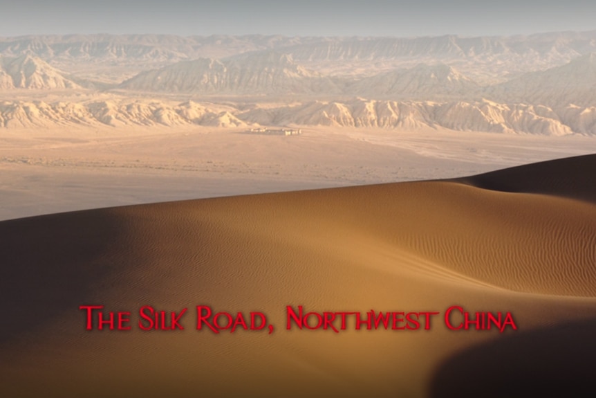 A desert landscape with the words "The Silk Road, Northwest China" superimposed.
