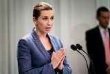 Denmark's Prime Minister Mette Frederiksen speaking into a microphone.