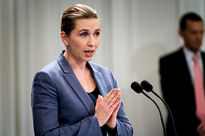 Denmark's Prime Minister Mette Frederiksen speaking into a microphone.