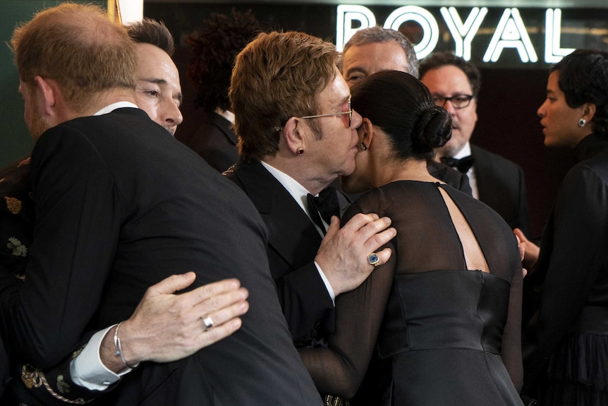 Elton John hugs Meghan Markle at Lion King premiere.