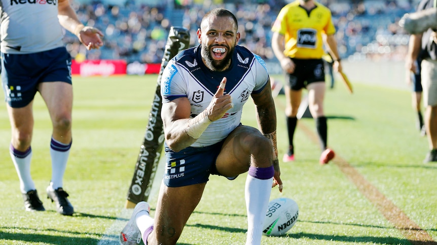 Melbourne Storm winger Josh Addo-Carr smiles and raises his index finger after scoring a try against the Warriors.