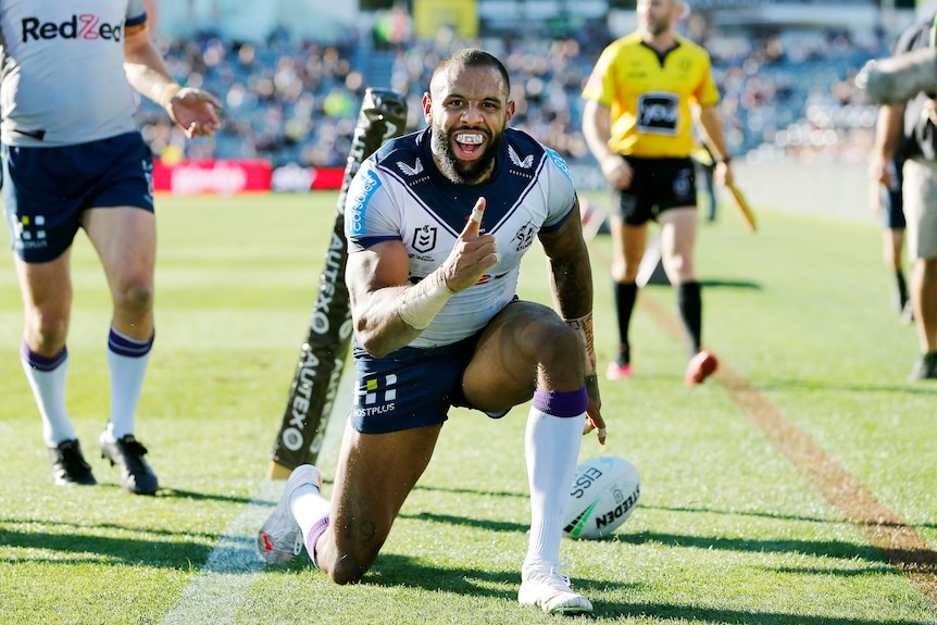 Melbourne Storm winger Josh Addo-Carr smiles and raises his index finger after scoring a try against the Warriors.