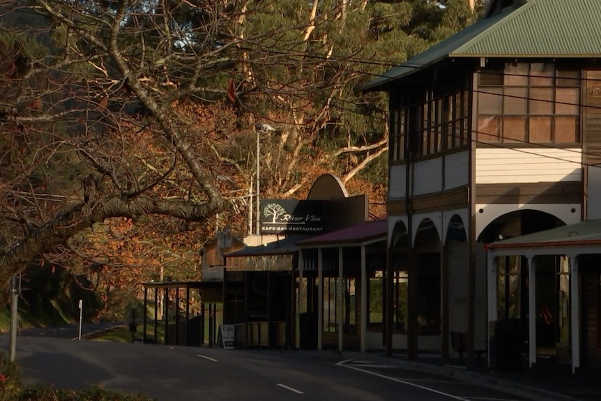 The main strip of shops in Warburton is shown alongside a road. 