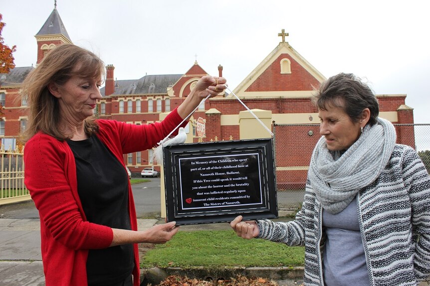 Gabrielle Short and Wendy Dykof outside Nazareth House in Ballarat holding a plaque to remember former resident children.