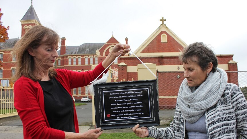 Gabrielle Short and Wendy Dykof outside Nazareth House in Ballarat holding a plaque to remember former resident children.