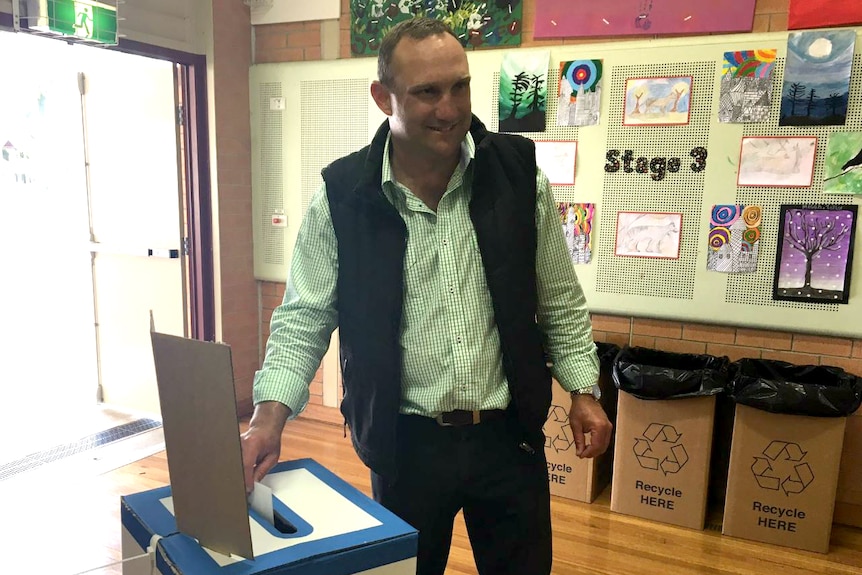 Nationals candidate Scott Barrett putting his ballot in the ballot box.