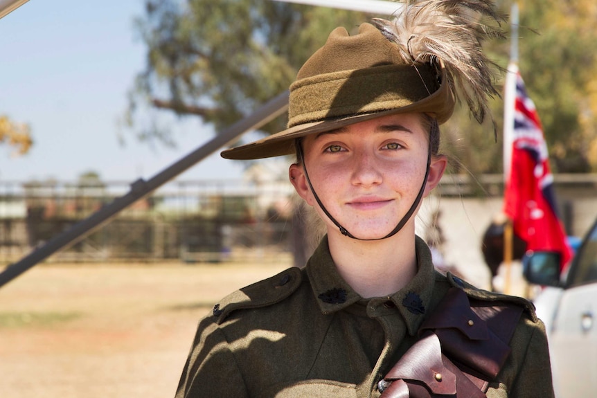 A young girl in traditional Light Horse uniform staring right into the lens. Close up shot. Blurred background.