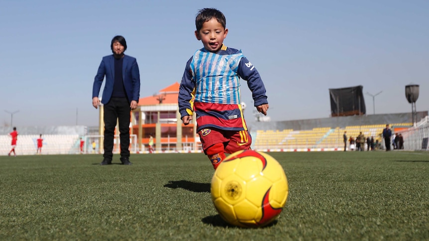 Afghan boy Murtaza Ahmadi wears a Lionel Messi shirt made of a plastic bag in Kabul in February 2016.