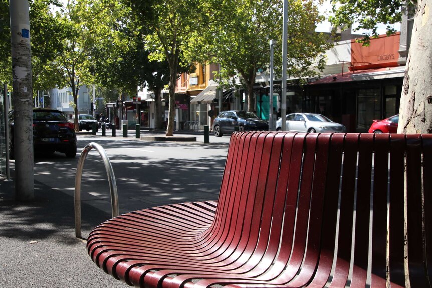 An empty bench on Melbourne's usually busy Lygon Street.