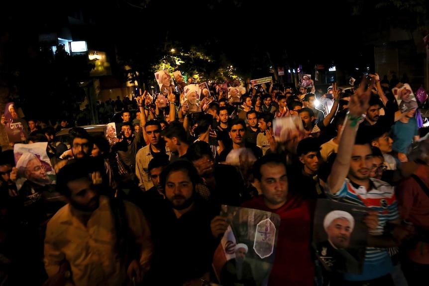 Supporters of Iranian President Hassan Rouhani attend a street campaign.