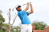 Curtis Luck swinging a golf club.