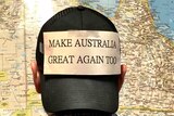 Man with his back to the camera wearing a hat which reads "Make Australia Great Again Too"