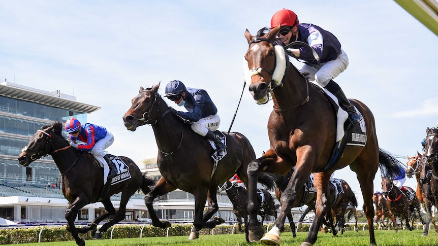Three jockeys race to the finish line in the 2020 Melbourne Cup.