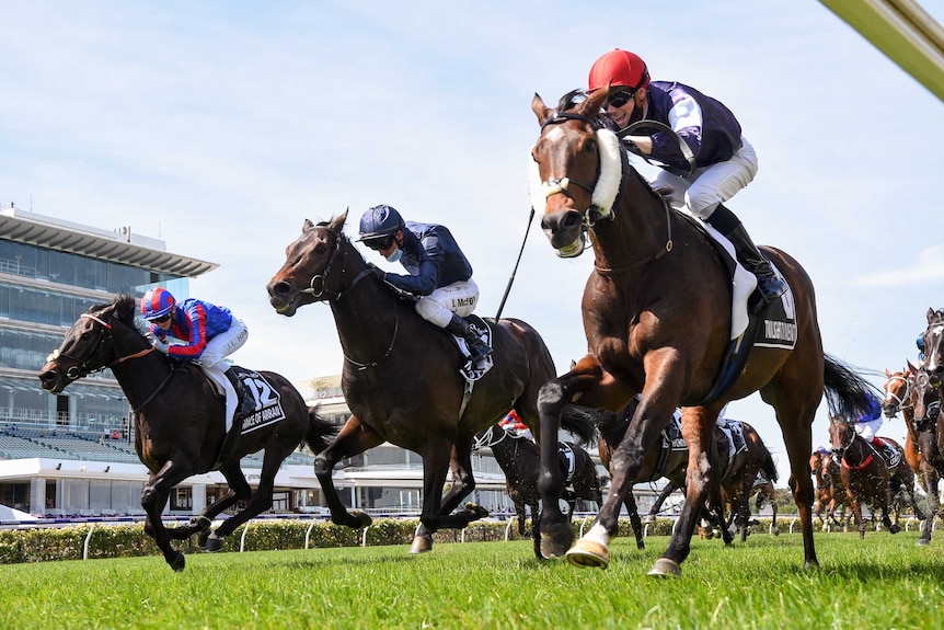 Three jockeys race to the finish line in the 2020 Melbourne Cup.