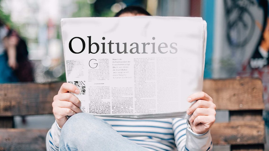 Man reading newspaper on a park bench for a story about celebrating people's lives through obituaries.