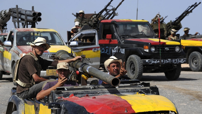 Libyan National Transition Council fighters gather on the outskirts of Sirte