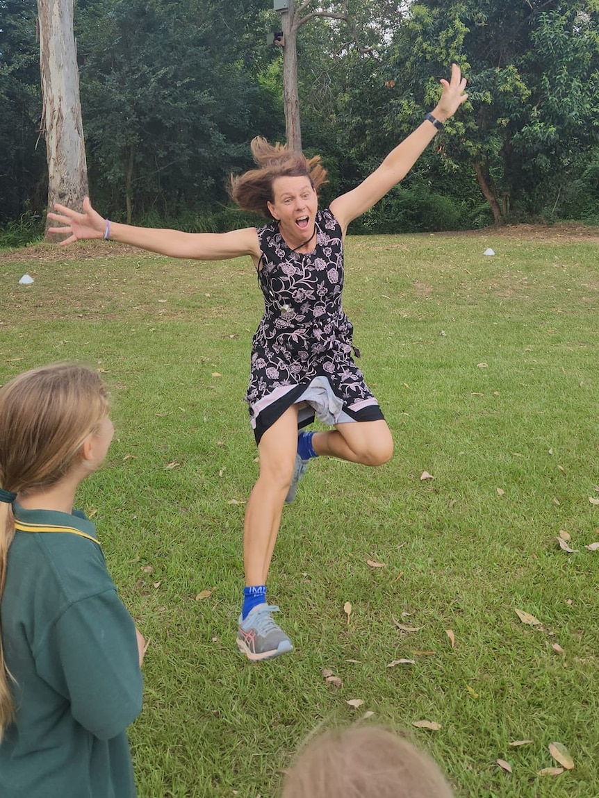 Woman wearing a dress jumping up in air