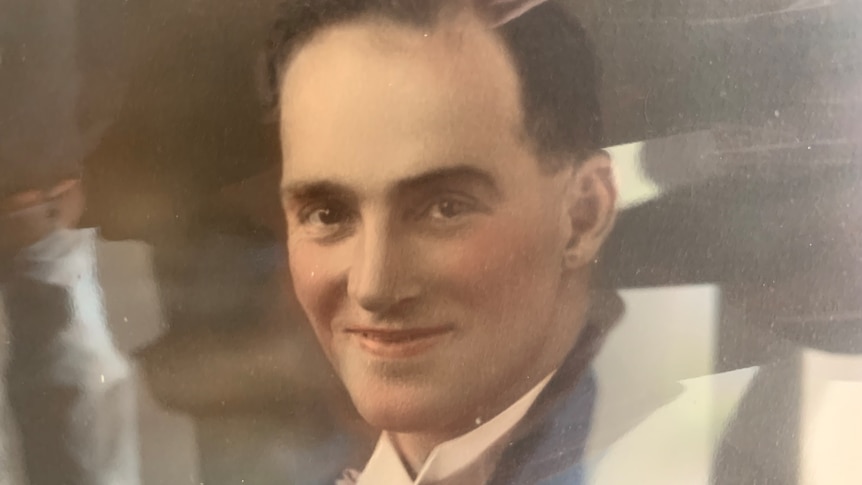 An old photo of a man smiling 