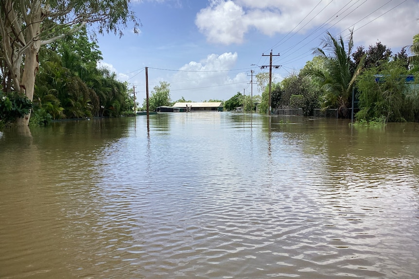 A street flooded with water in a tropical town