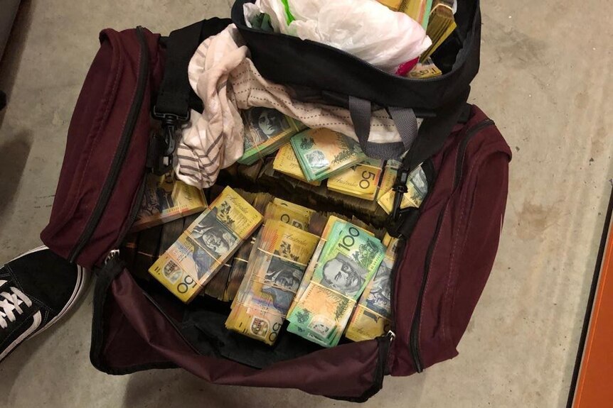 A sports bag filled with $50 and $100 notes.