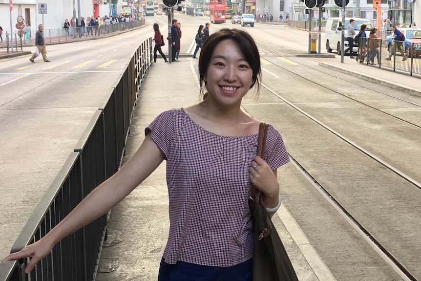 Nicole Xie stands on the tram tracks in Melbourne.