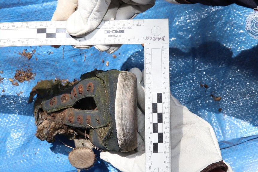 Crime scene photograph of the toe of a shoe found by police