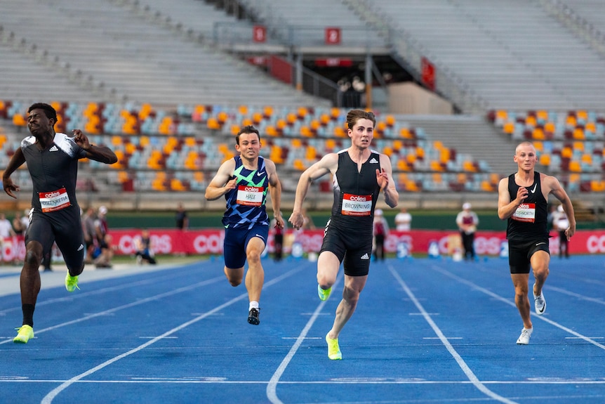 Rohan Browning races three opponents in a running event at the Queensland Track Classic.