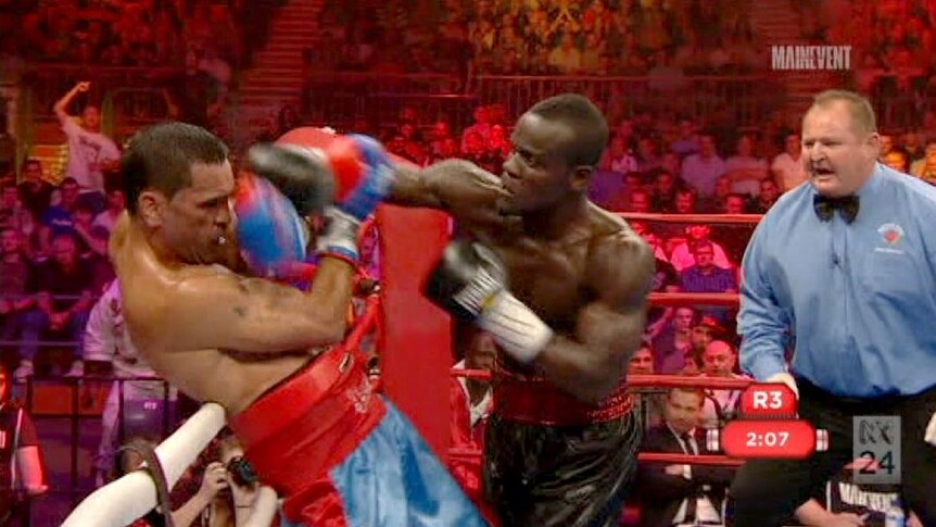 Anthony Mundine defends himself against Joshua Clottey at the Newcastle Entertainment Centre.