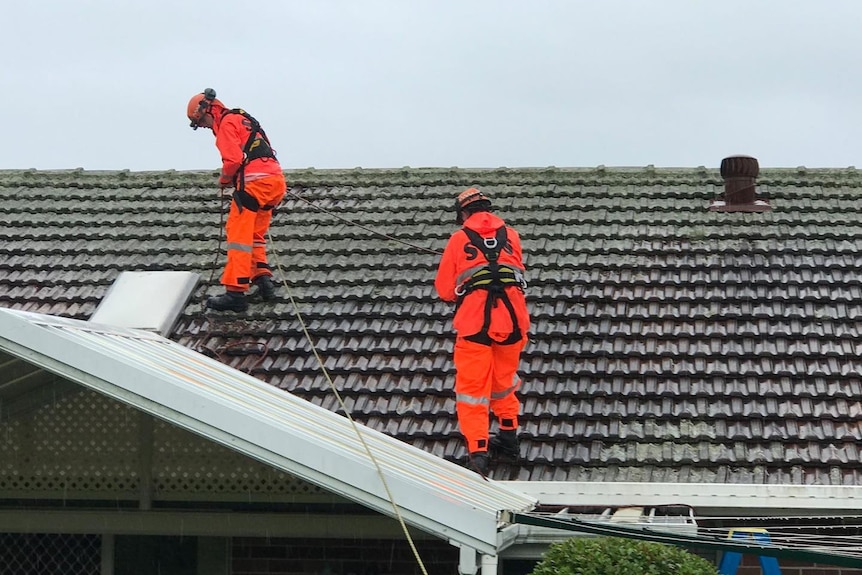 SES volunteers on a roof