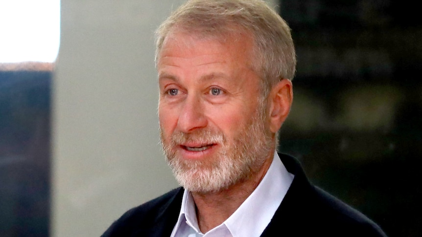 Roman Abramovich smiles wearing an open necked shirt