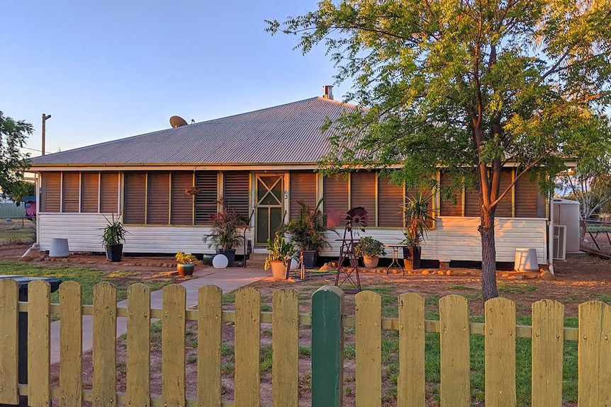 A low-set house with a green fence used in the film Total Control