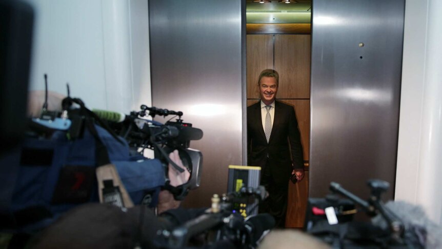 Christopher Pyne grins as he gets into a lift at Parliament