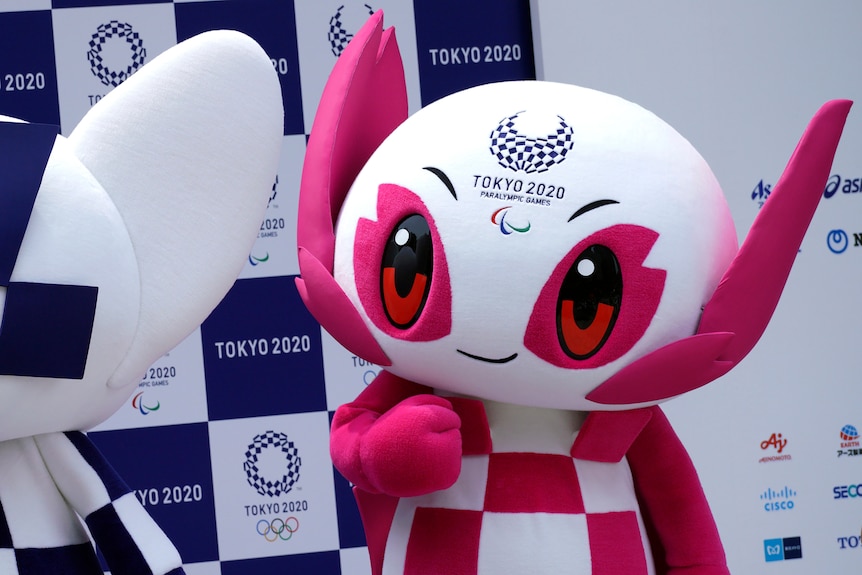 A pink and white robot like mascot suit with big anime style eyes.