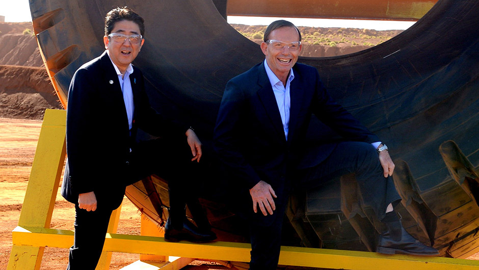Tony Abbott and Shinzo Abe show off the RM Williams boots in front of a tyre