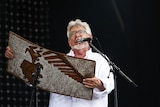 Rolf Harris performs with his wobble-board