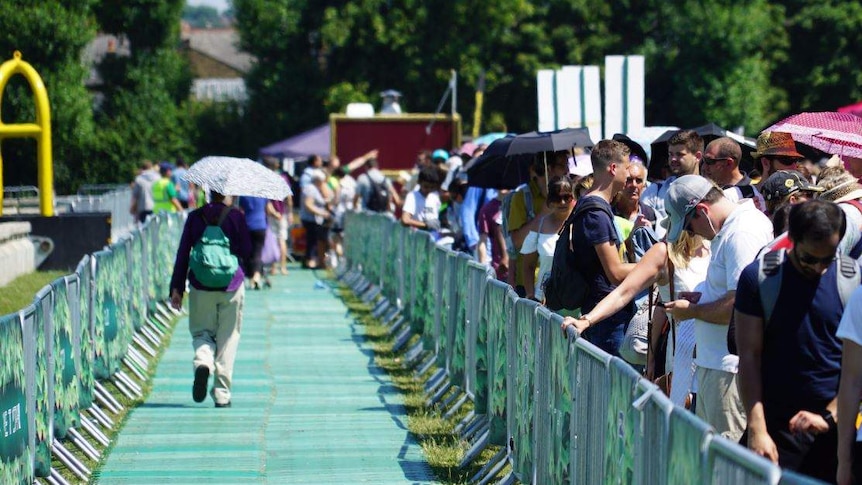 People experience a nervous wait at Wimbledon