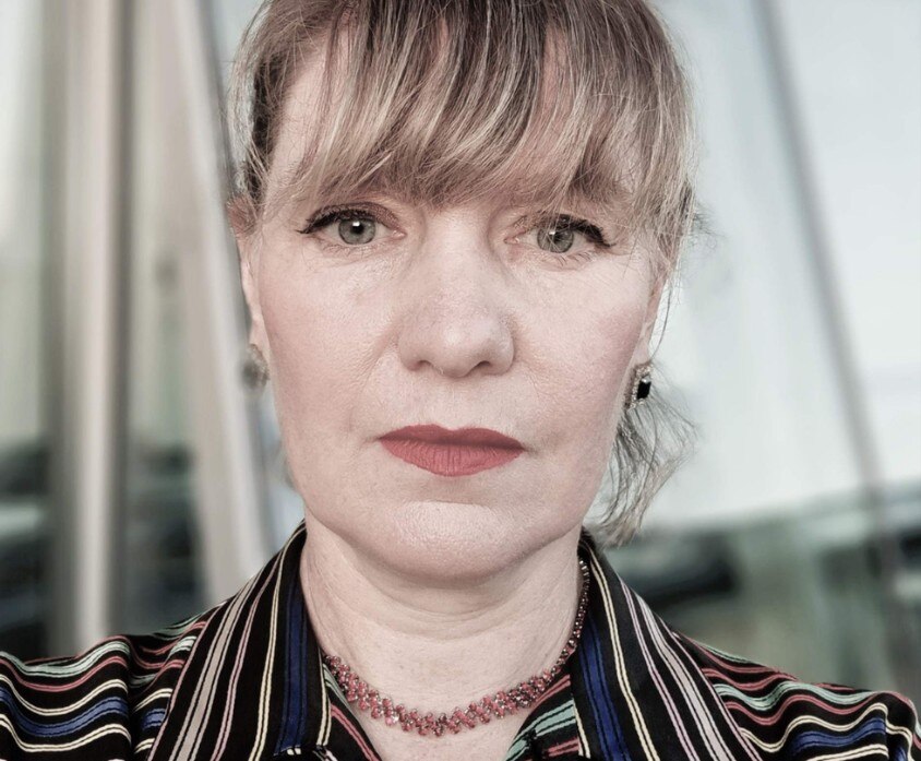 a close up of a woman's face with fringe