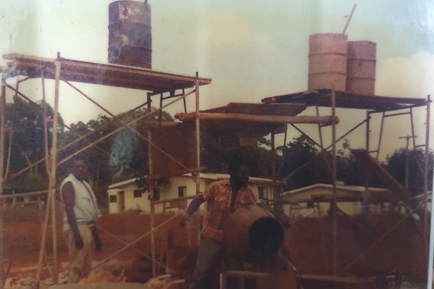 Two Indigenous men standing on a building site 