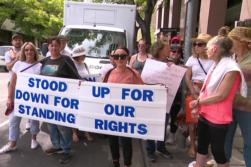 People protesting holding signs