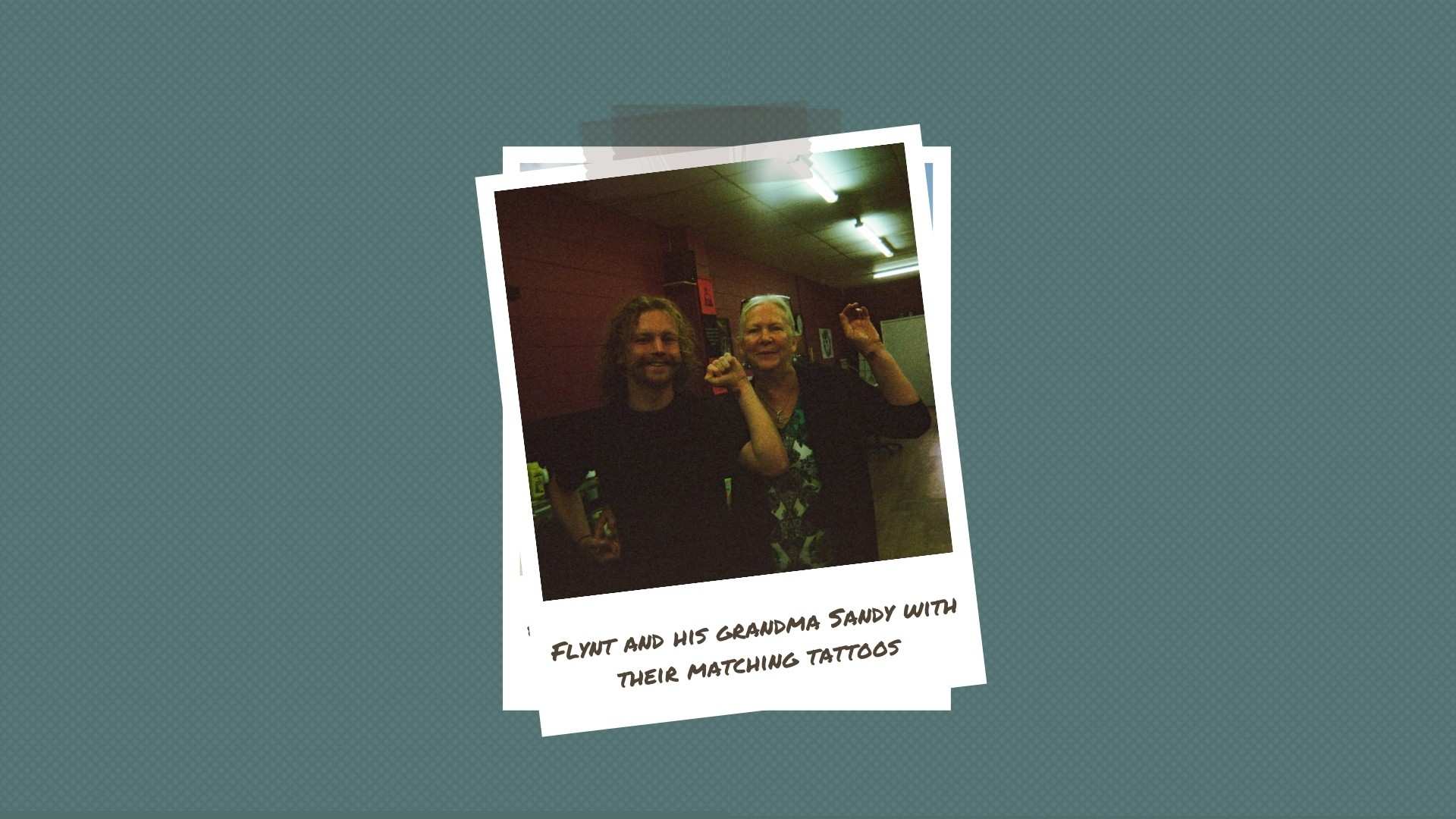 A young man and elderly woman show off fresh tattoos on their wrists