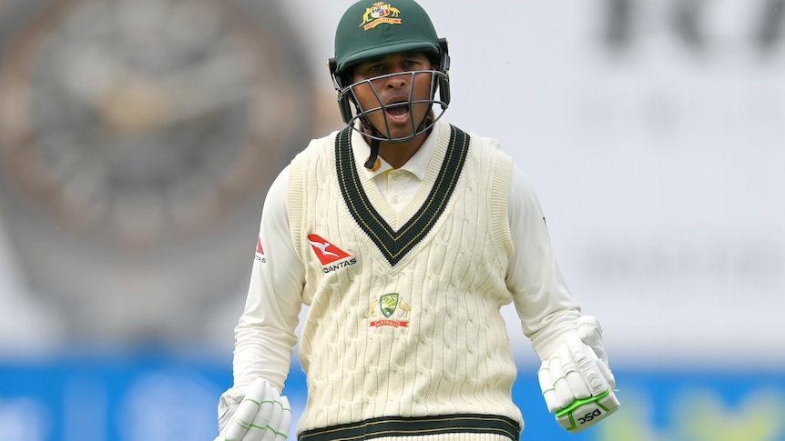Usman Khawaja clenches both fists and yells in delight