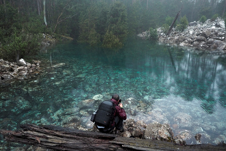 Man photographs Mount Wellington tarn