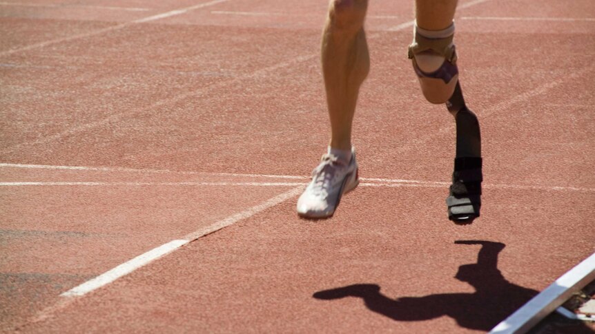 A person running on a track with a prosthetic.